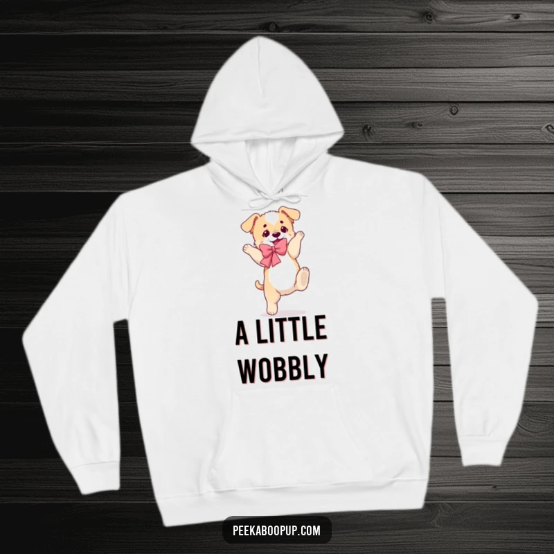Funny hoodie displaying a puppy in a fluffy bow, executing a clumsy somersault with a goofy look.